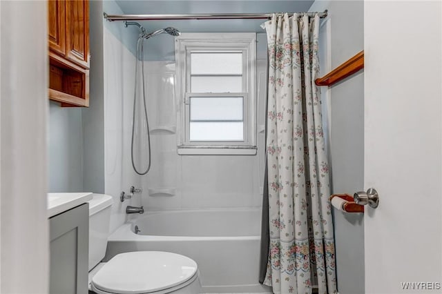 bathroom featuring toilet, shower / bath combo, and vanity