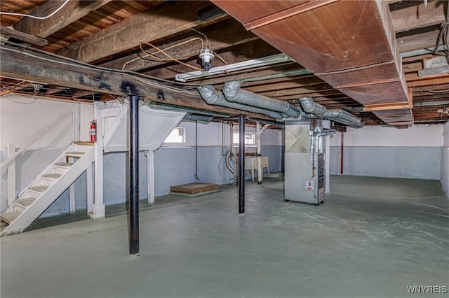 basement with heating unit and stairs