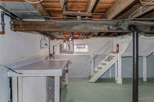 basement featuring stairway and electric panel