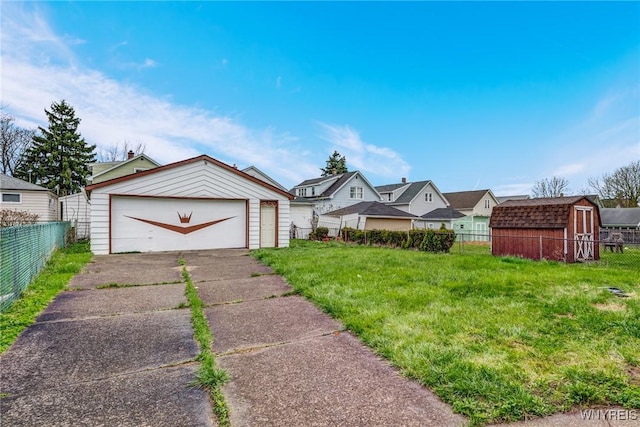 view of front of home with a garage, fence, and an outdoor structure