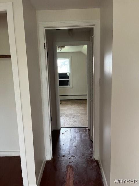 hall with hardwood / wood-style floors, baseboard heating, and baseboards
