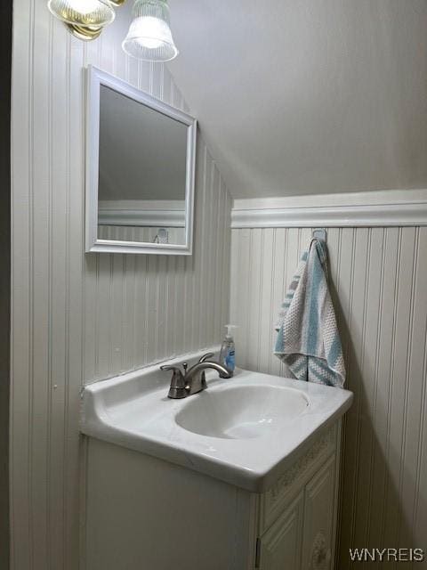 bathroom featuring vaulted ceiling and vanity