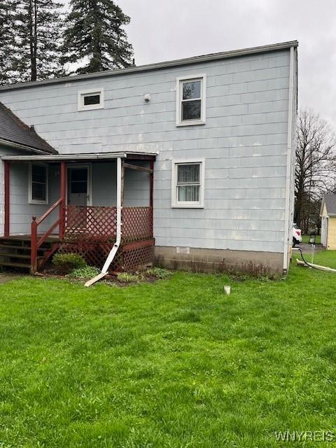 rear view of property featuring a yard