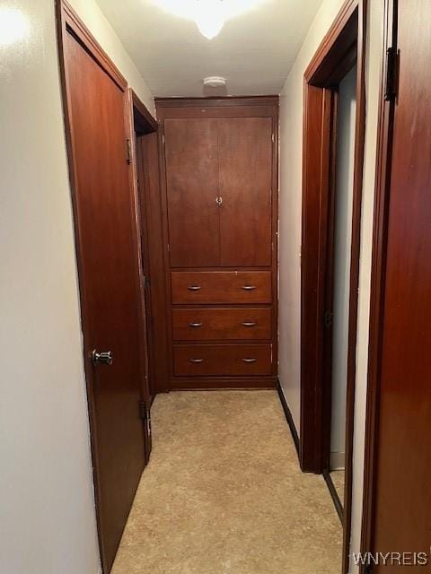 corridor featuring light colored carpet