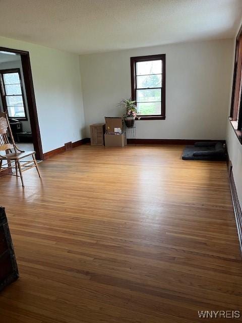 unfurnished room featuring baseboards and wood finished floors