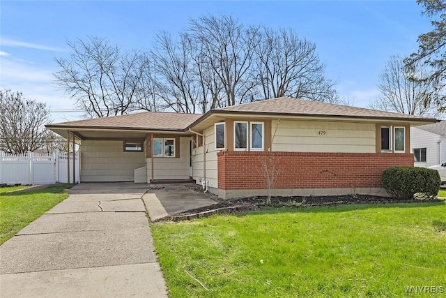 single story home with brick siding, fence, a front yard, and concrete driveway
