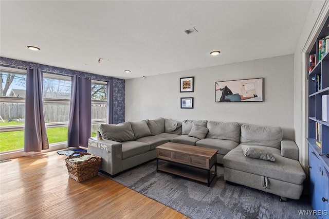 living area featuring wood finished floors and recessed lighting