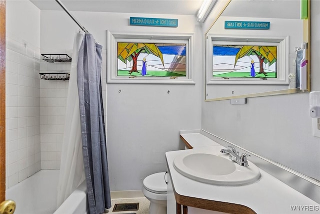 bathroom with a wealth of natural light, toilet, shower / tub combo with curtain, and vanity
