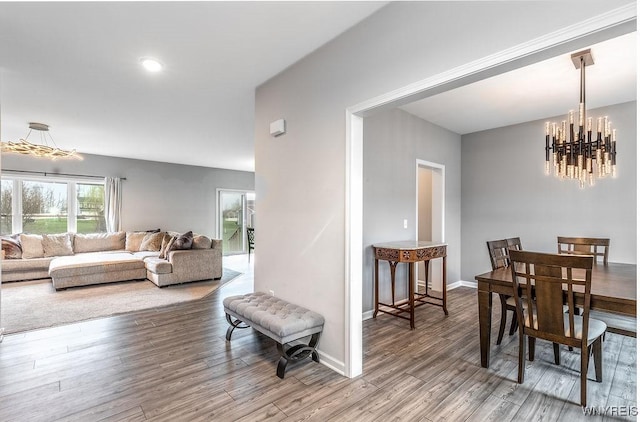 dining room with an inviting chandelier, wood finished floors, and baseboards