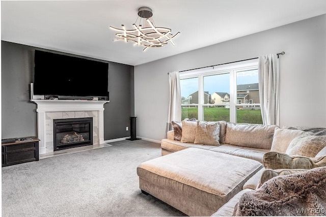 carpeted living room with a chandelier, baseboards, and a fireplace