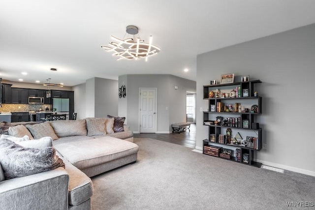 living area featuring an inviting chandelier, recessed lighting, carpet flooring, and baseboards