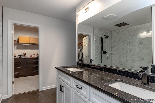 full bathroom with tile patterned flooring, a stall shower, double vanity, and a sink