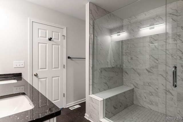full bathroom featuring double vanity, a sink, baseboards, visible vents, and a stall shower