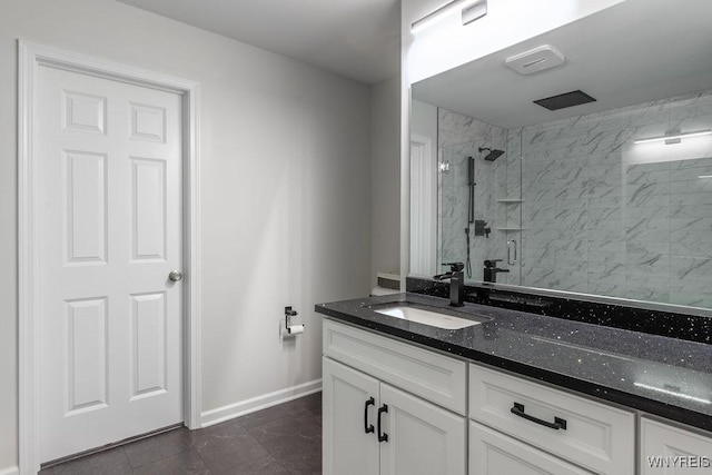 bathroom with baseboards, a stall shower, and vanity