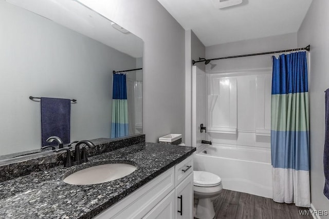 full bathroom featuring wood finished floors, toilet, vanity, and shower / tub combo with curtain