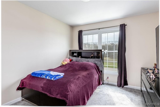 bedroom with baseboards, carpet floors, and multiple windows