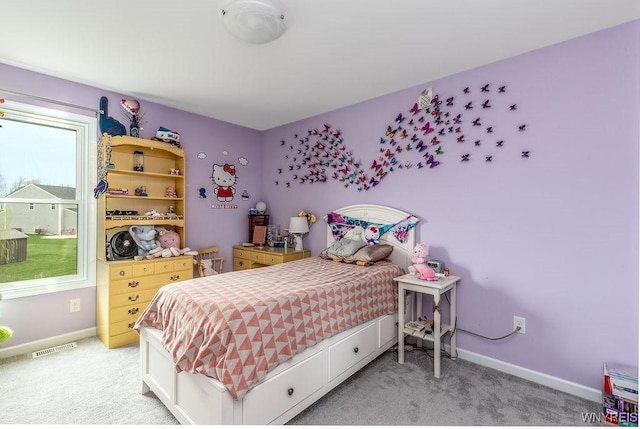 bedroom with visible vents, light colored carpet, and baseboards