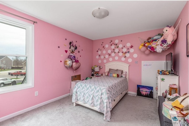 bedroom featuring baseboards and light carpet