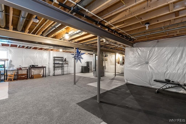 unfinished basement featuring heating unit