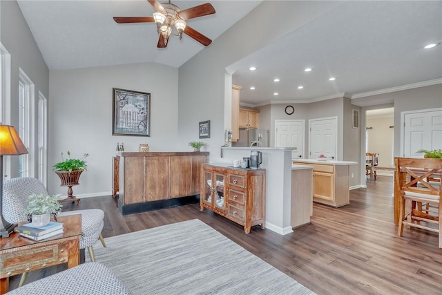 kitchen featuring recessed lighting, wood finished floors, baseboards, a ceiling fan, and a peninsula
