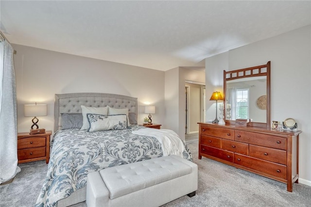 bedroom with baseboards and carpet