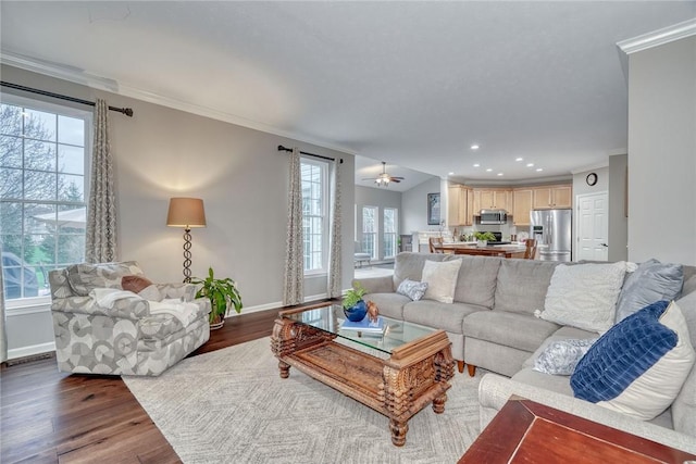 living room featuring baseboards, recessed lighting, ornamental molding, wood finished floors, and a ceiling fan