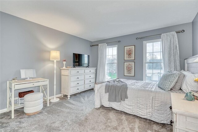 carpeted bedroom featuring baseboards