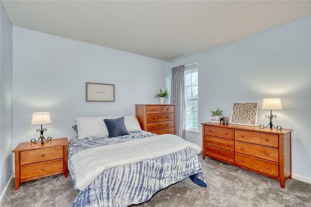 bedroom featuring baseboards and carpet flooring