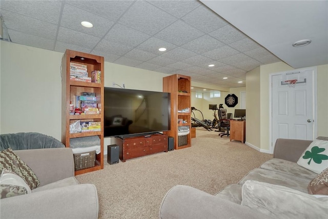 living room with baseboards, recessed lighting, carpet floors, and a drop ceiling