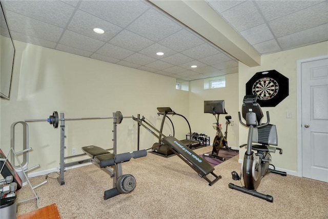 exercise area with a paneled ceiling, carpet flooring, recessed lighting, and baseboards