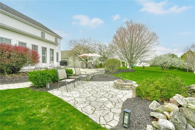 view of yard featuring a patio and a fire pit