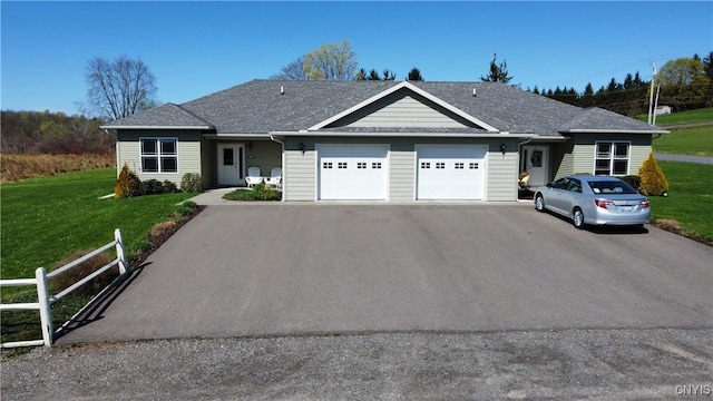 view of front of property featuring a garage, a shingled roof, aphalt driveway, and a front lawn