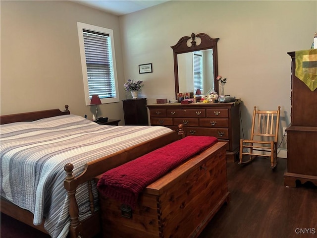 bedroom with dark wood-style flooring