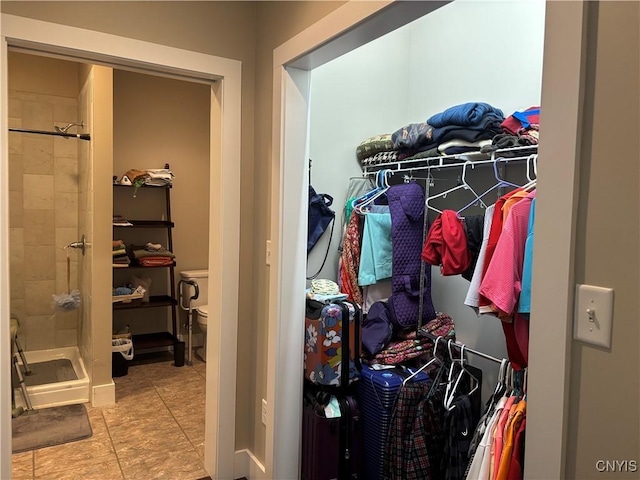 spacious closet with light tile patterned floors