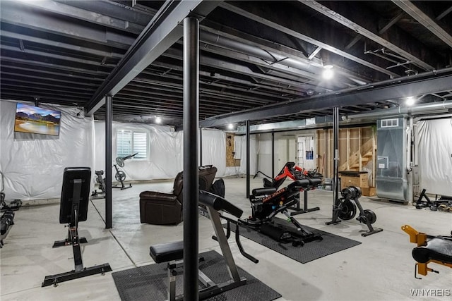 workout room featuring visible vents and heating unit