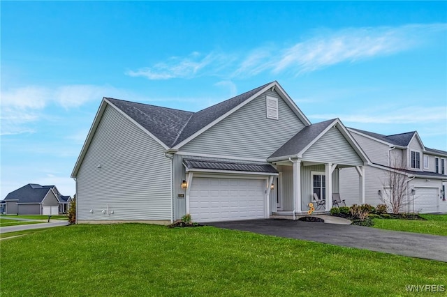 view of front of house with a garage, a front lawn, and aphalt driveway