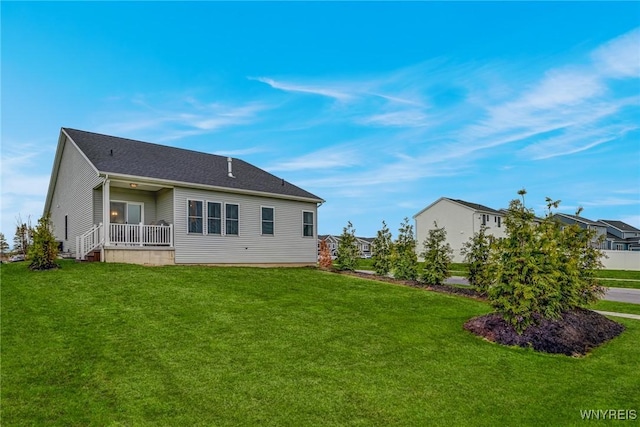rear view of house with a lawn
