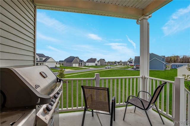 view of patio / terrace with covered porch, a residential view, and a grill