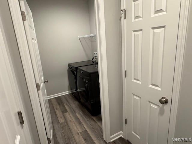 laundry area featuring separate washer and dryer, baseboards, laundry area, and dark wood-style floors