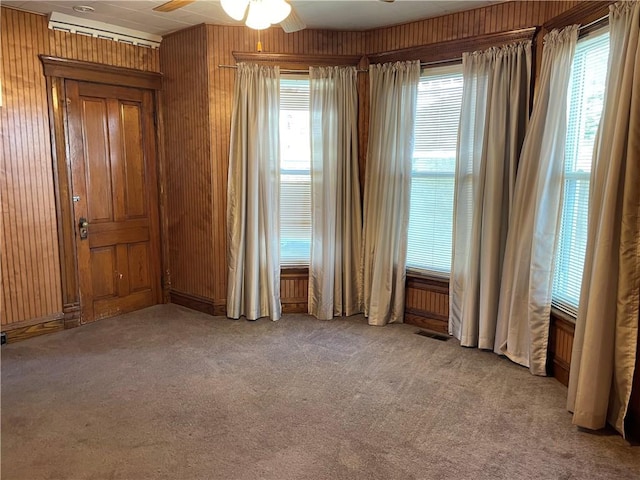 spare room with visible vents, ceiling fan, a wealth of natural light, and carpet floors