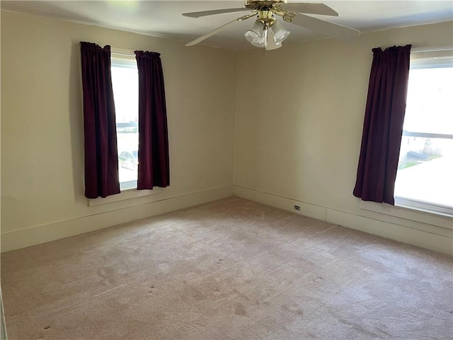 spare room with ceiling fan and carpet floors