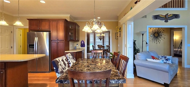 dining area featuring a chandelier, visible vents, light wood-type flooring, recessed lighting, and ornamental molding