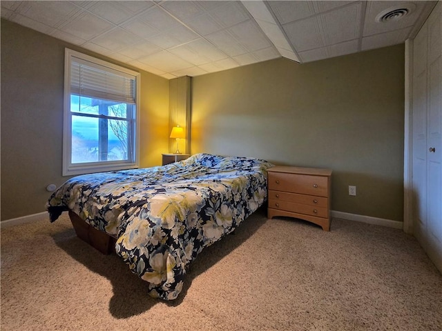 bedroom featuring visible vents, carpet, and baseboards