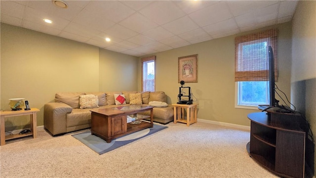 carpeted living area with baseboards
