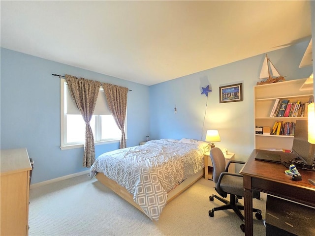 carpeted bedroom featuring baseboards