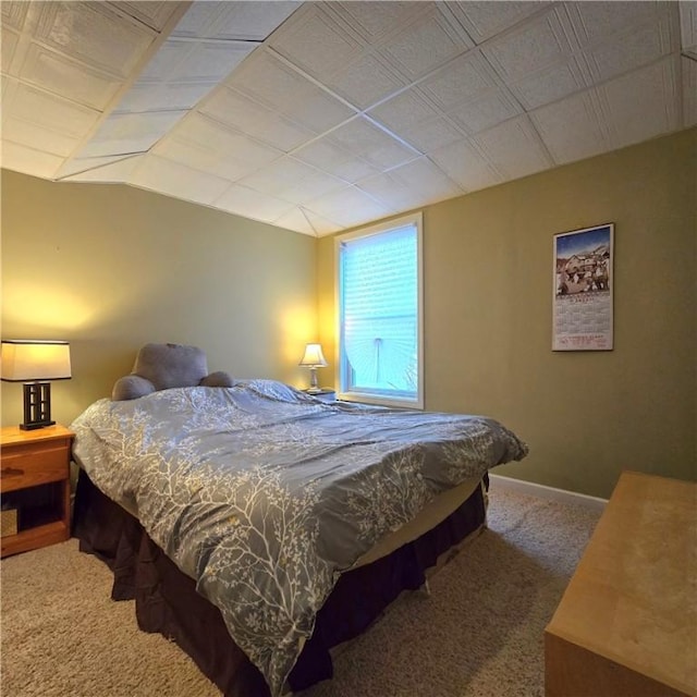bedroom with carpet floors and lofted ceiling