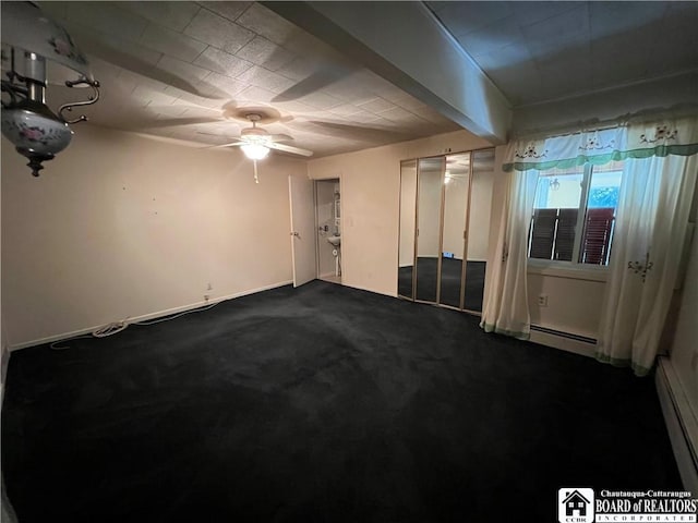 unfurnished room with dark colored carpet, a ceiling fan, and a baseboard radiator