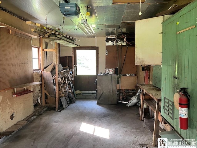 miscellaneous room featuring a workshop area and concrete floors