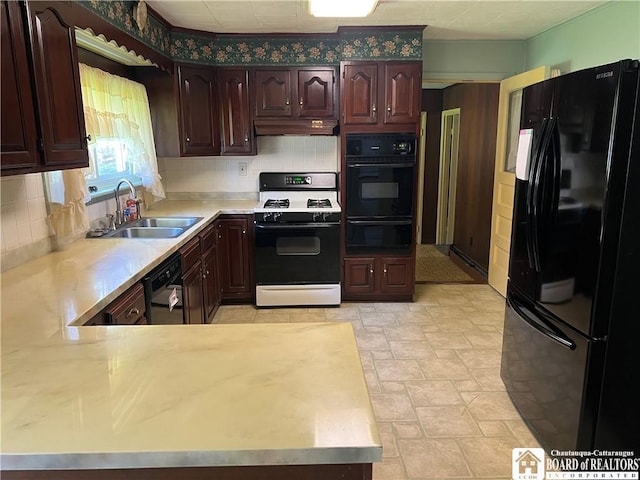kitchen with a sink, tasteful backsplash, a warming drawer, black appliances, and light countertops