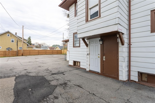 view of side of property featuring fence